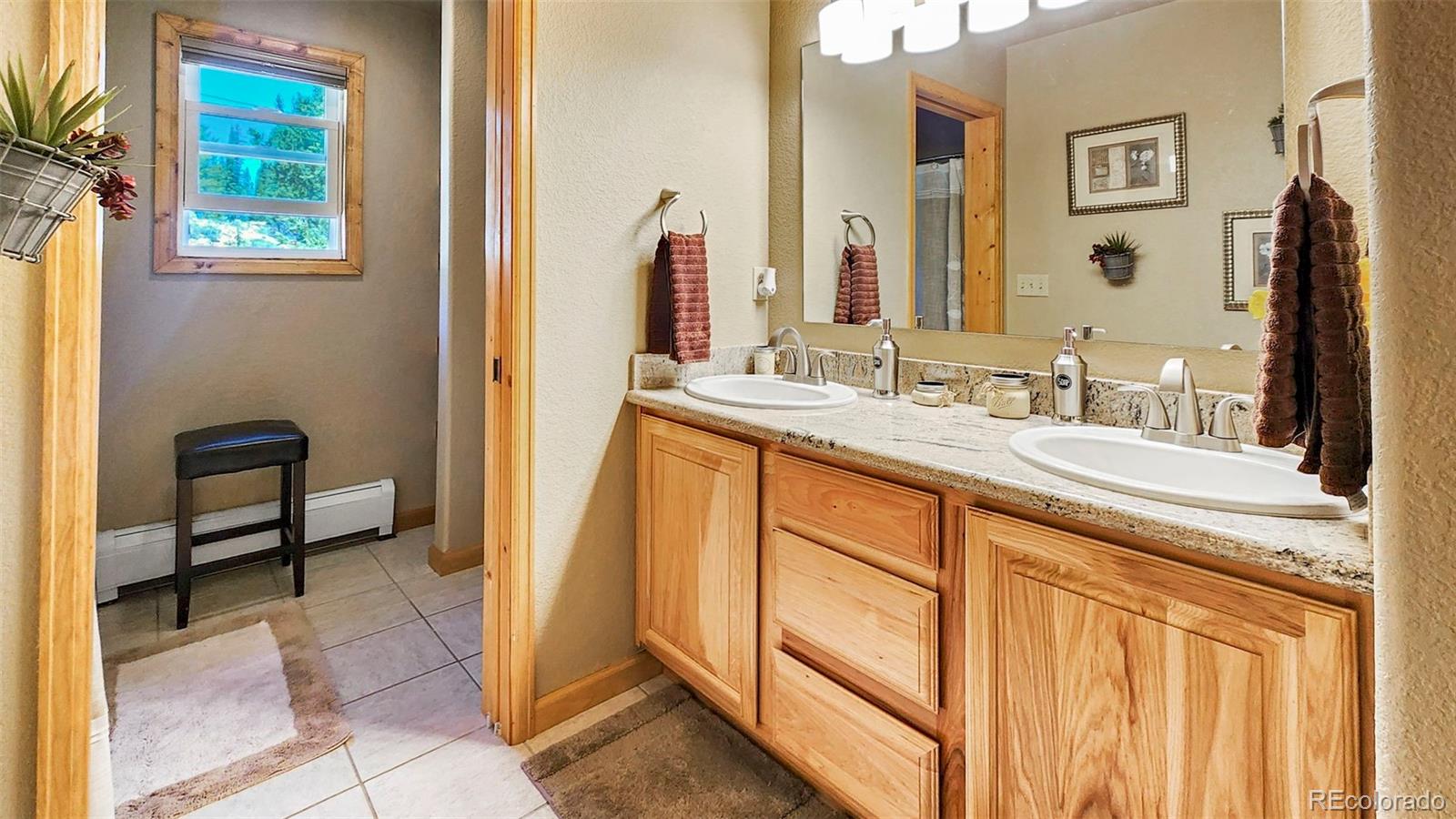 378 Silver Heels Circle Fairplay, CO 80440 - Photo 15 of 40 a bathroom with a sink a vanity and a mirror