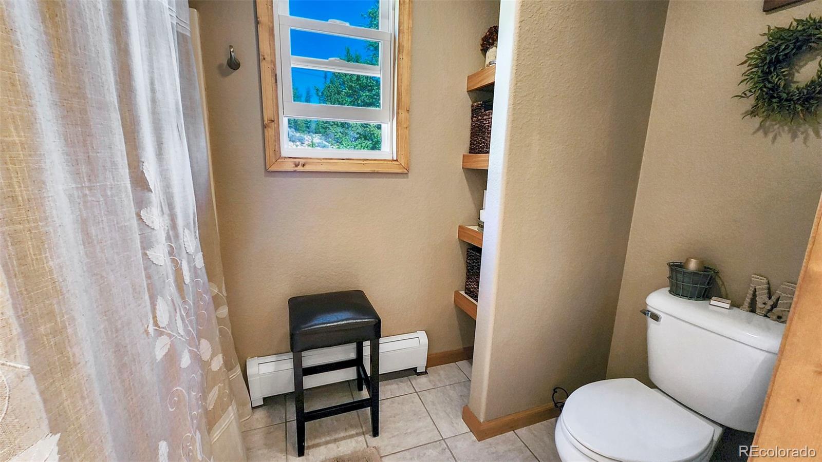 378 Silver Heels Circle Fairplay, CO 80440 - Photo 16 of 40 a white toilet sitting next to a bathroom sink