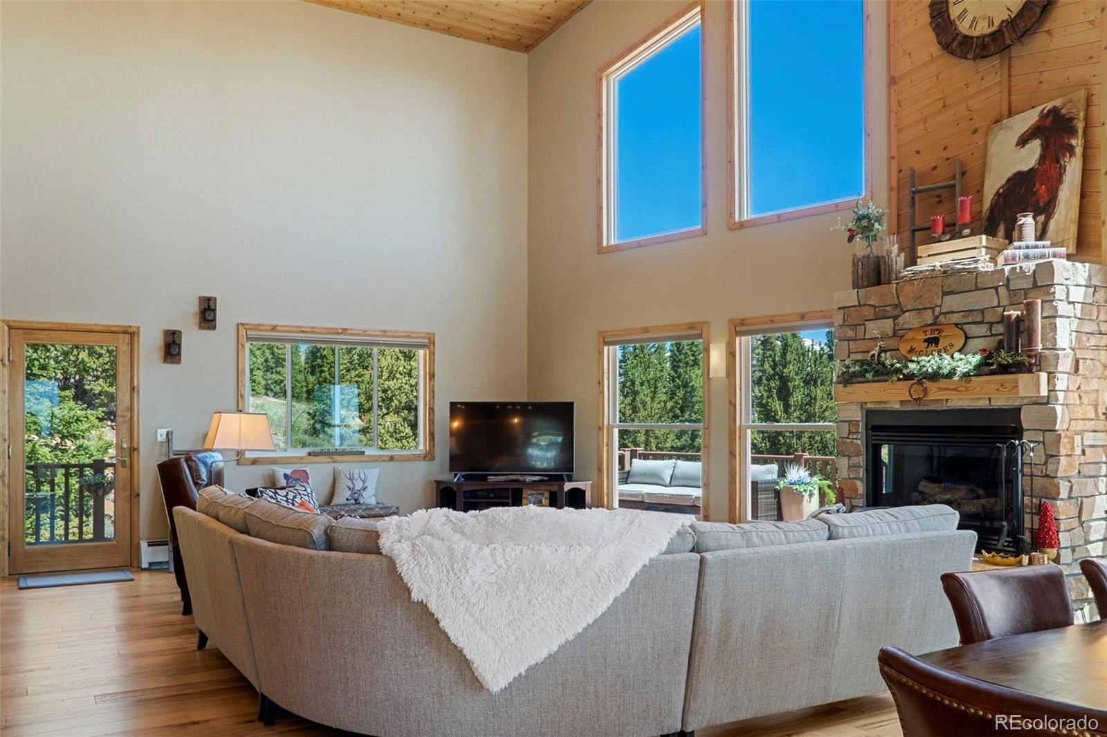 378 Silver Heels Circle Fairplay, CO 80440 - Photo 20 of 40 a living room with furniture a fireplace and a large window