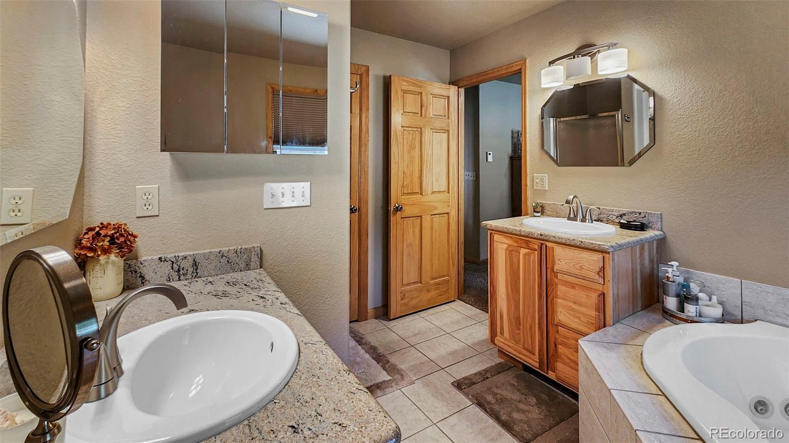 378 Silver Heels Circle Fairplay, CO 80440 - Photo 37 of 40 a bathroom with a sink toilet and mirror