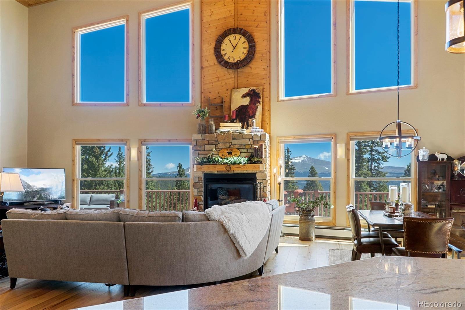 378 Silver Heels Circle Fairplay, CO 80440 - Photo 10 of 40 a living room with furniture a fireplace and floor to ceiling windows