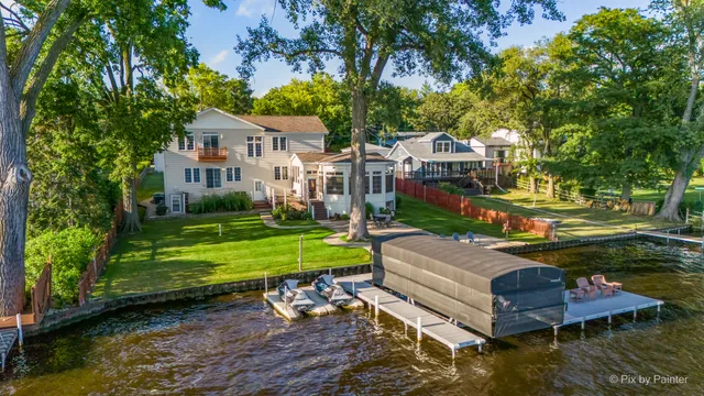 an aerial view of a house with a garden and swimming pool