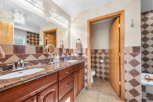 a bathroom with a sink a toilet and shower curtain