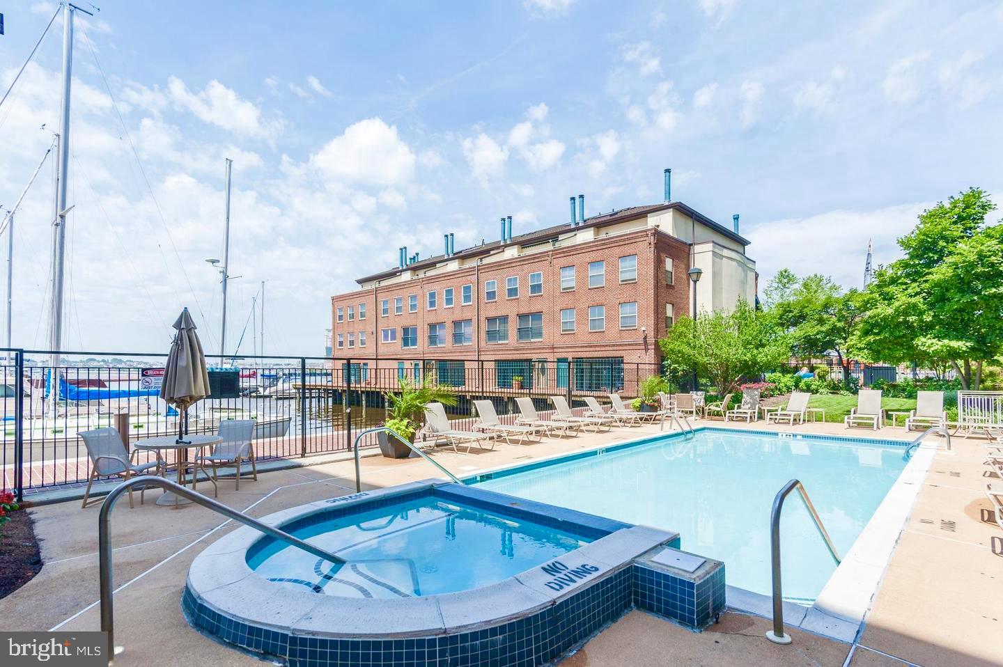 960 Fell Street, Unit 609 Baltimore, MD 21231 - Photo 13 of 45 a swimming pool with outdoor seating and barbeque oven