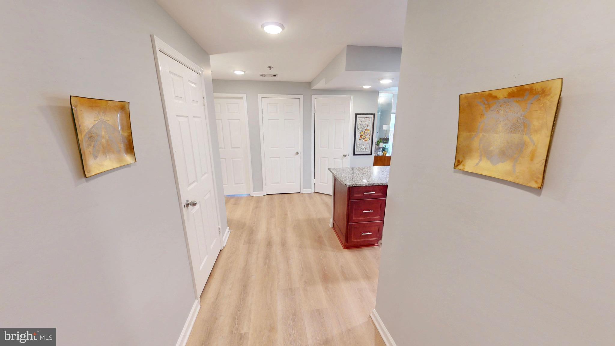 960 Fell Street, Unit 609 Baltimore, MD 21231 - Photo 15 of 45 a view of a hallway with paintings on the wall