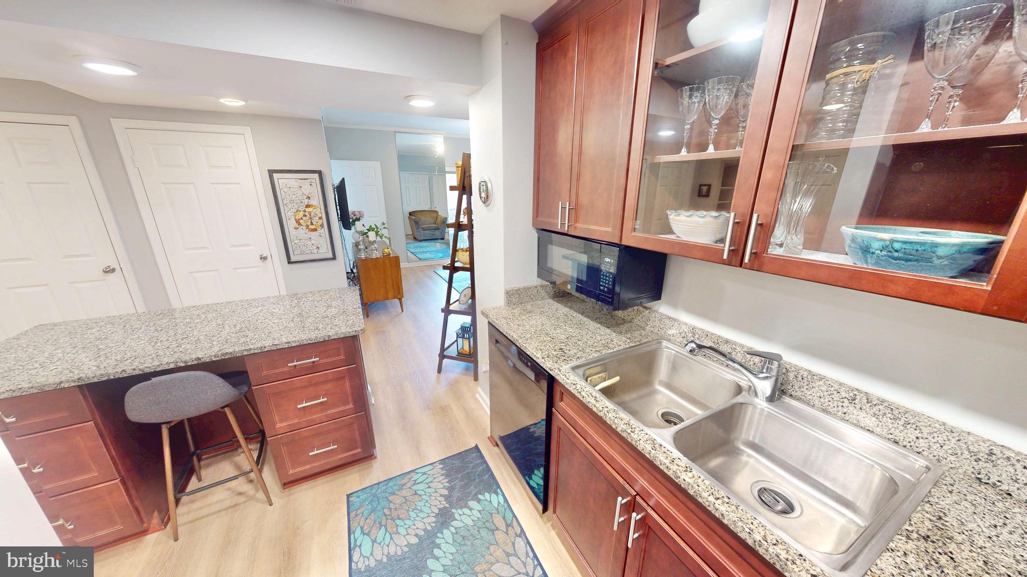960 Fell Street, Unit 609 Baltimore, MD 21231 - Photo 16 of 45 a kitchen with stainless steel appliances granite countertop a sink and a stove