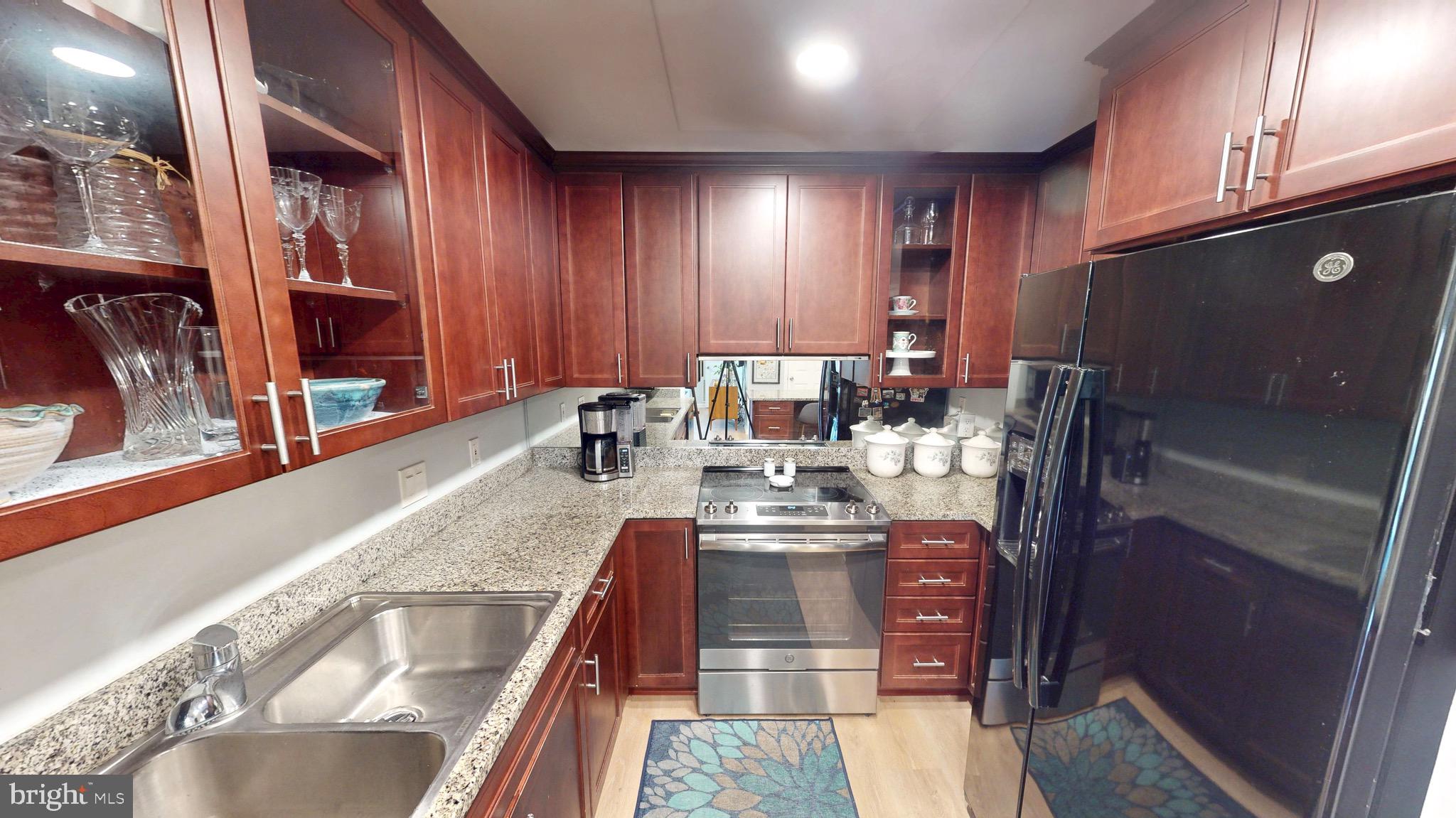960 Fell Street, Unit 609 Baltimore, MD 21231 - Photo 17 of 45 a kitchen with stainless steel appliances granite countertop wooden cabinets a oven and granite counter tops
