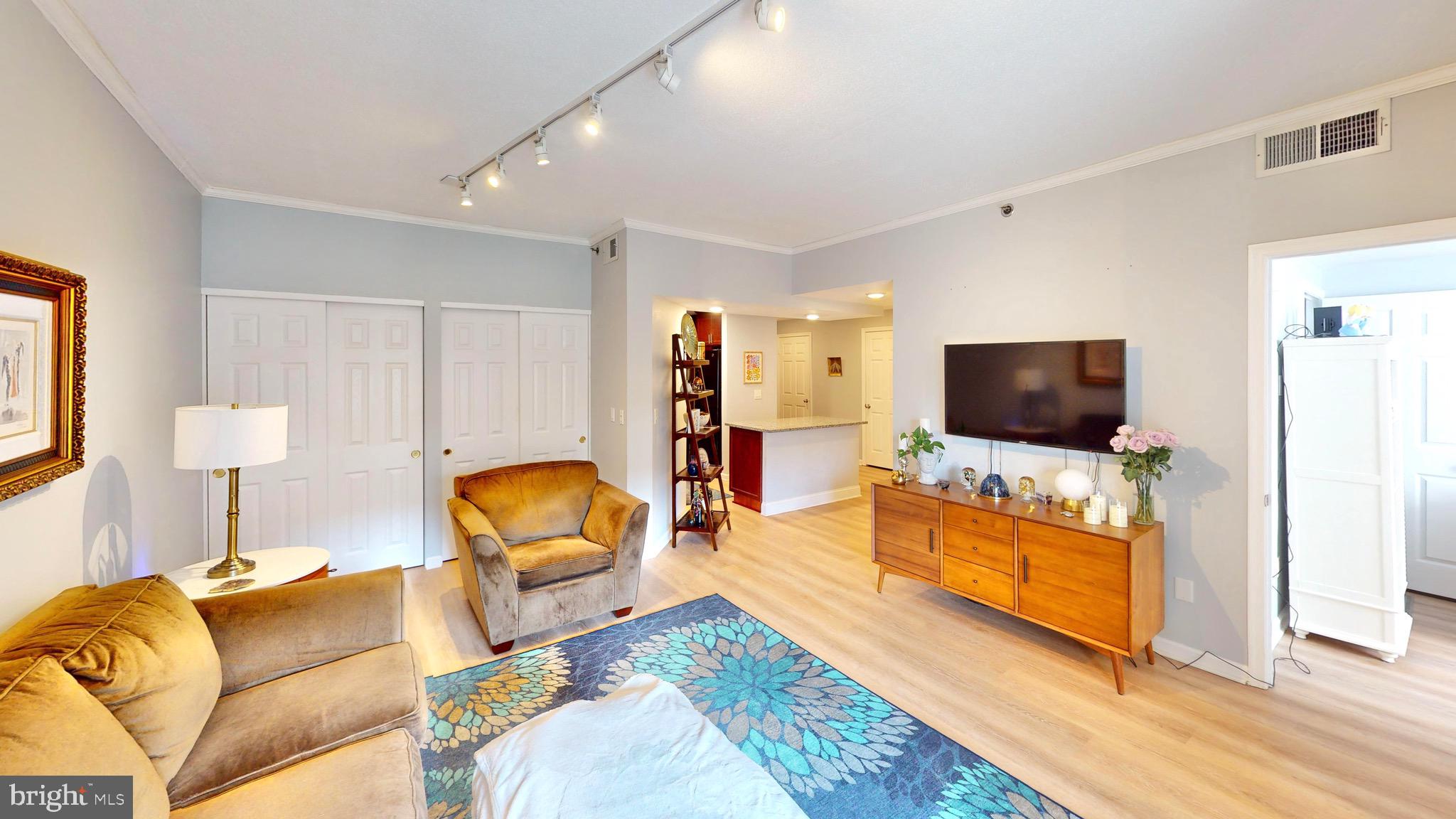 960 Fell Street, Unit 609 Baltimore, MD 21231 - Photo 19 of 45 a living room with furniture and a flat screen tv