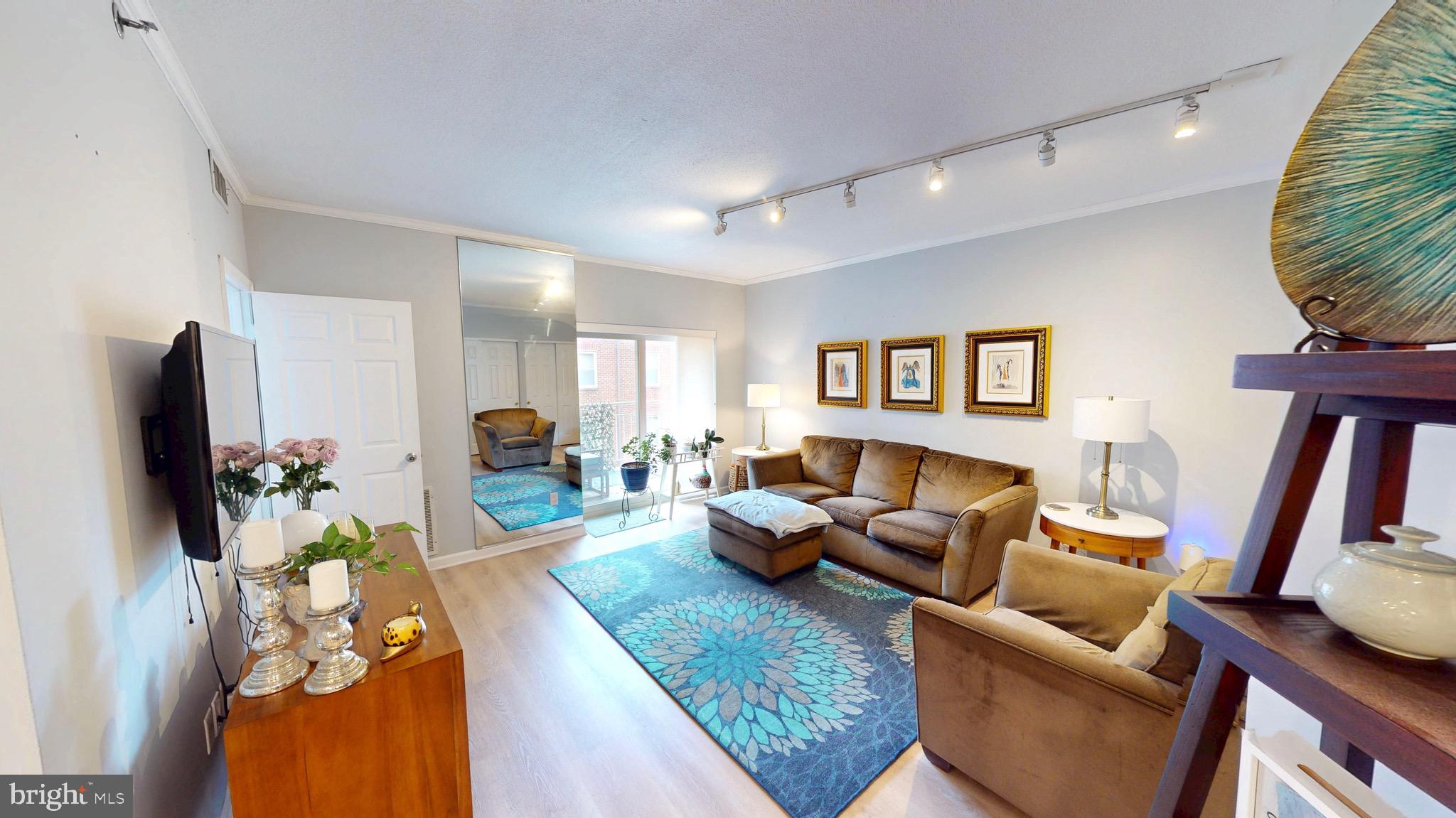 960 Fell Street, Unit 609 Baltimore, MD 21231 - Photo 22 of 45 a living room with furniture and a flat screen tv