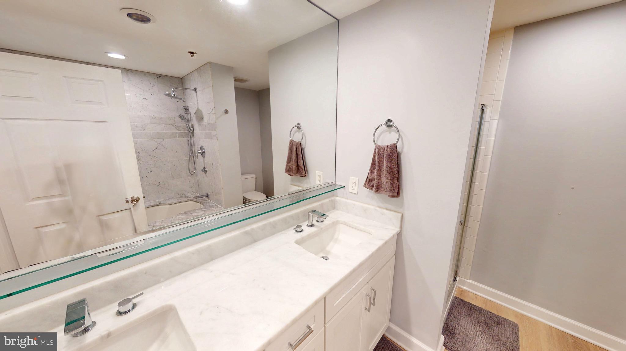 960 Fell Street, Unit 609 Baltimore, MD 21231 - Photo 29 of 45 a bathroom with a sink and a mirror