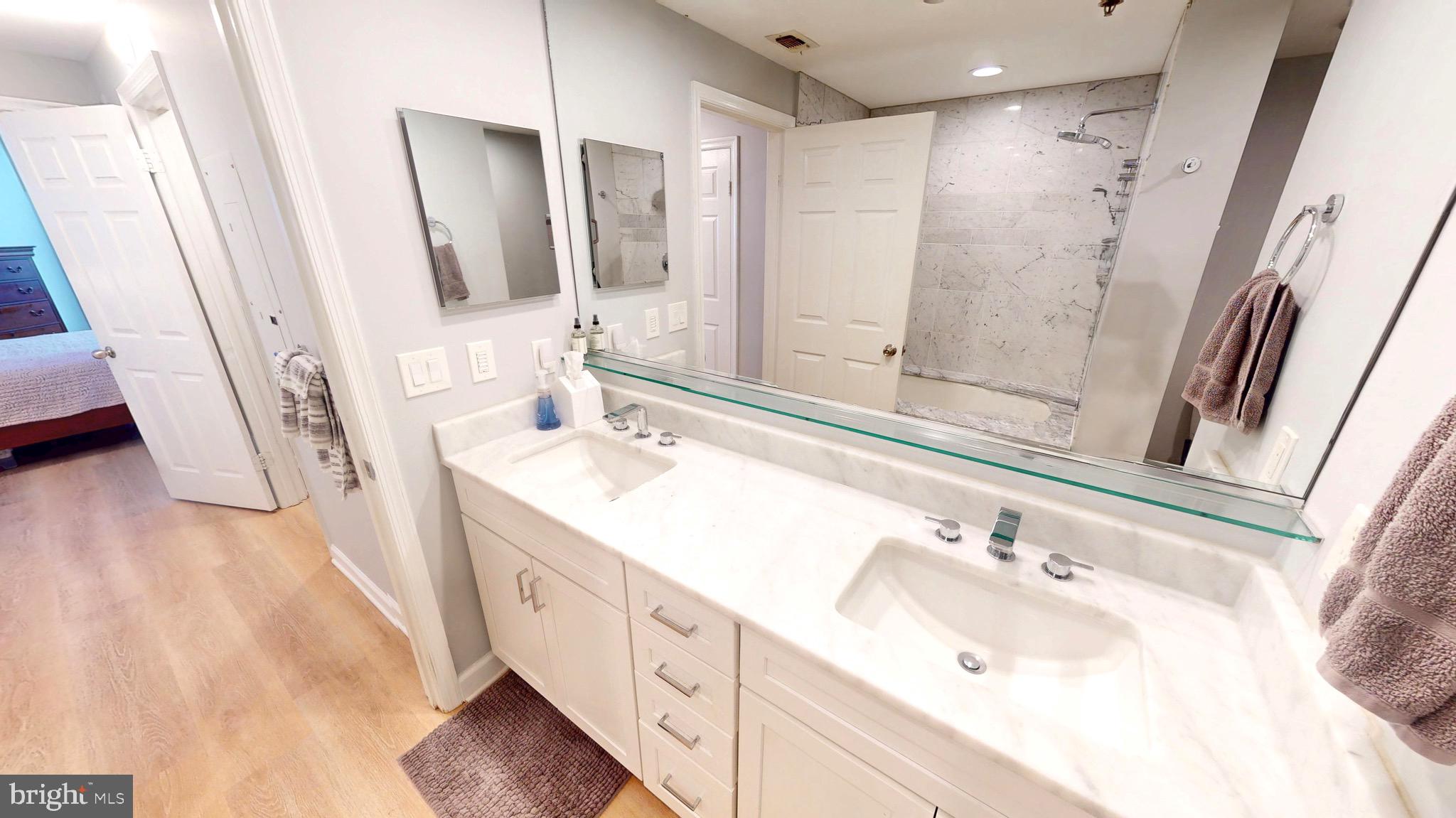 960 Fell Street, Unit 609 Baltimore, MD 21231 - Photo 5 of 45 a bathroom with a double vanity sink and mirror