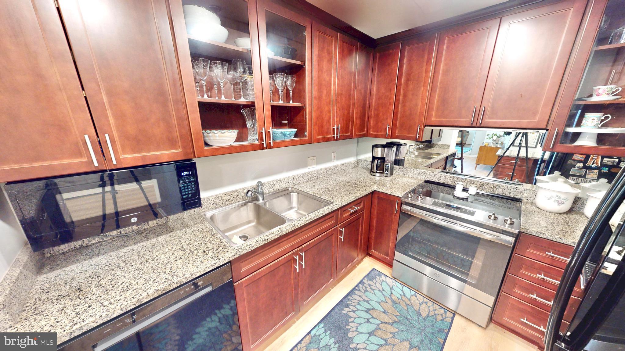 960 Fell Street, Unit 609 Baltimore, MD 21231 - Photo 8 of 45 a kitchen with stainless steel appliances granite countertop a sink stove and cabinets