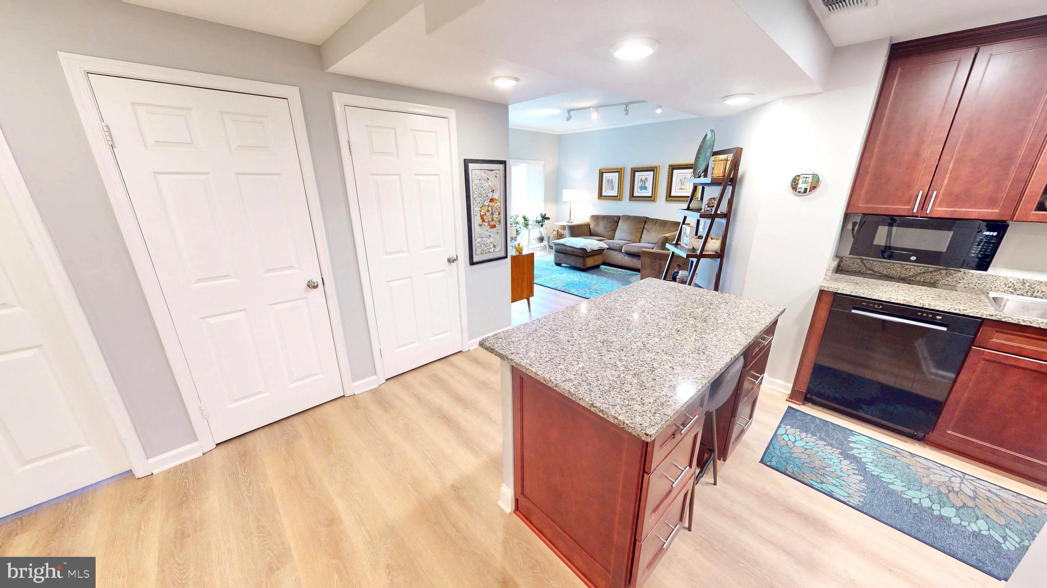 960 Fell Street, Unit 609 Baltimore, MD 21231 - Photo 10 of 45 a kitchen with stainless steel appliances granite countertop a refrigerator and a stove top oven