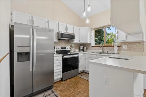 a kitchen with stainless steel appliances a refrigerator sink and microwave