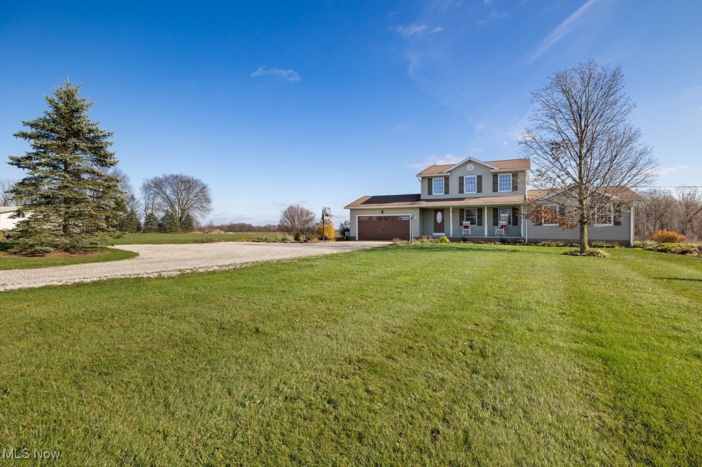 View of front of property with a front yard and a porch