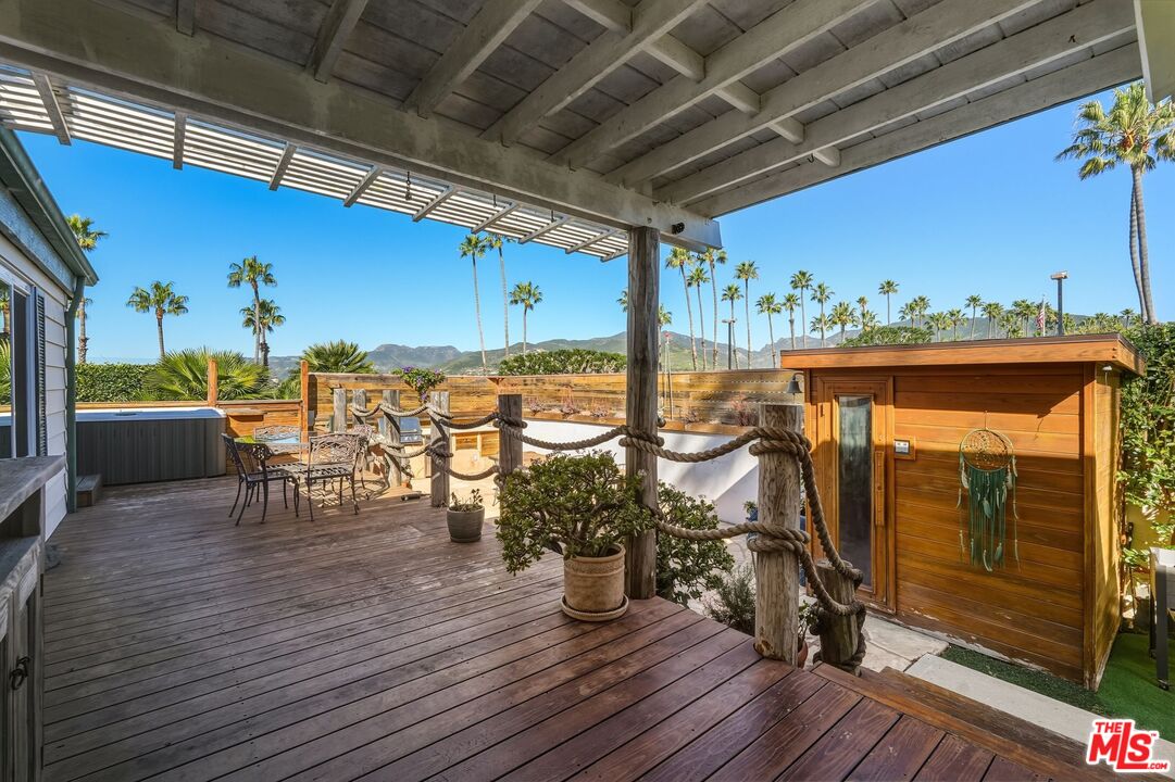 29500 Heathercliff Road, Unit 87 Malibu, CA 90265 - Photo 1 of 58 a view of a porch with furniture and wooden floor
