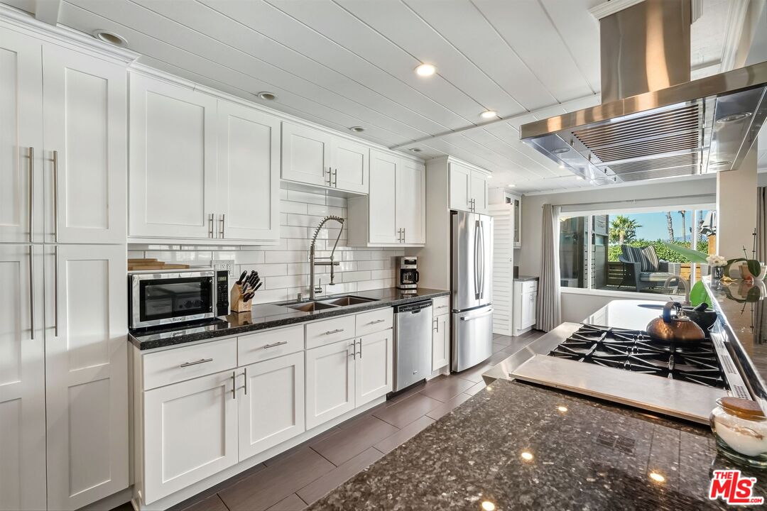 29500 Heathercliff Road, Unit 87 Malibu, CA 90265 - Photo 12 of 58 a kitchen with stainless steel appliances a stove a sink and a refrigerator