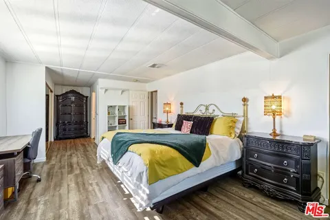 a living room with furniture fireplace and a large window