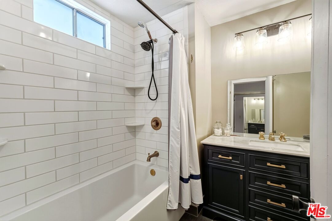 29500 Heathercliff Road, Unit 87 Malibu, CA 90265 - Photo 19 of 58 a bathroom with a bathtub a sink a vanity and a shower