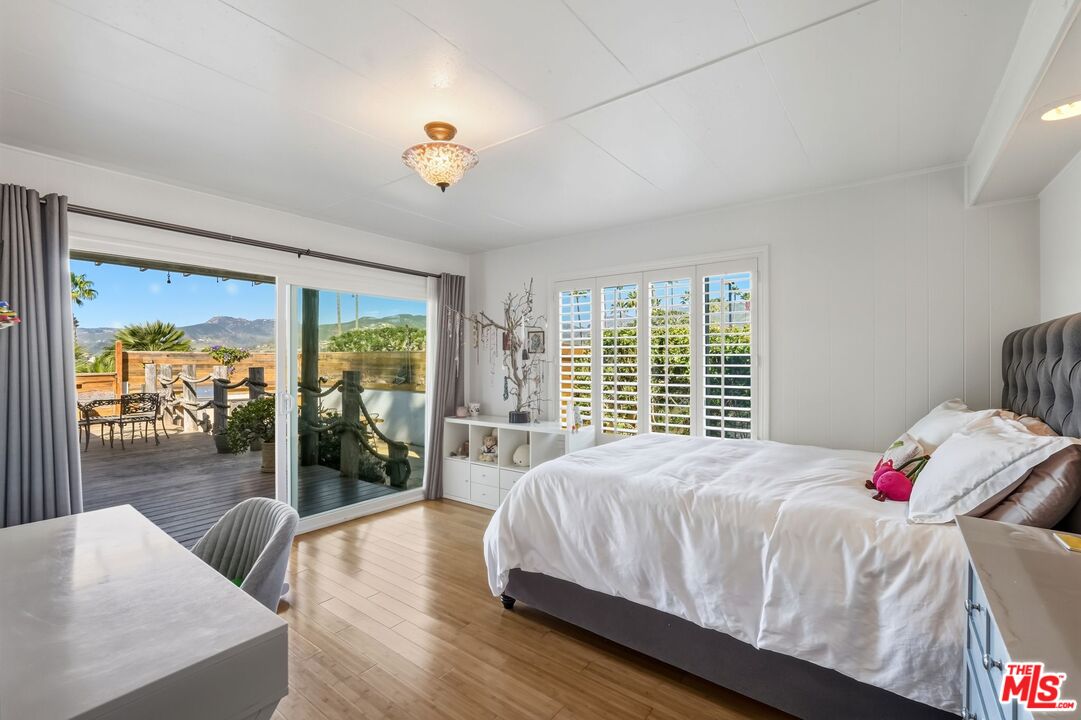 29500 Heathercliff Road, Unit 87 Malibu, CA 90265 - Photo 20 of 58 a bedroom with a bed and a large window