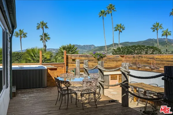 a view of balcony with chairs and wooden floor