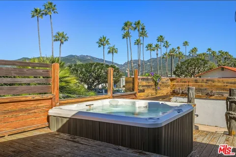 a view of balcony with chairs and wooden floor
