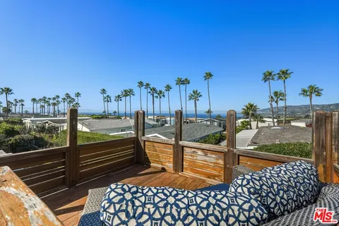 a view of a balcony with chairs