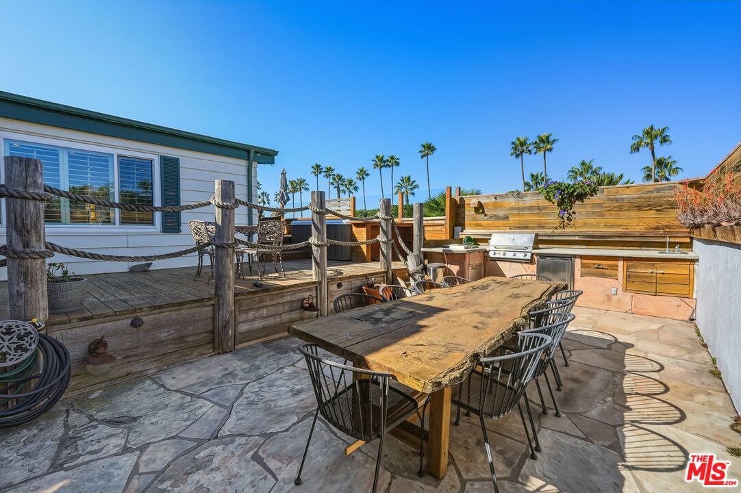 29500 Heathercliff Road, Unit 87 Malibu, CA 90265 - Photo 36 of 58 a view of a patio with table and chairs and potted plants