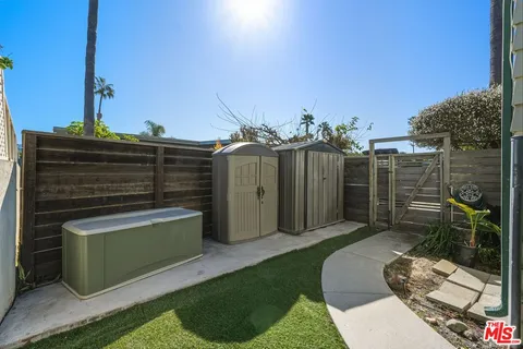 a view of a garden with a building in the background