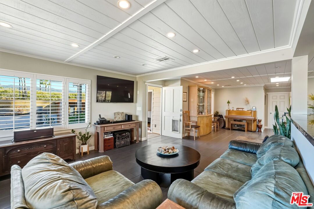 29500 Heathercliff Road, Unit 87 Malibu, CA 90265 - Photo 8 of 58 a living room with furniture and a flat screen tv