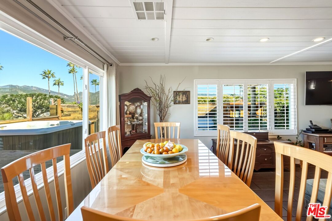 29500 Heathercliff Road, Unit 87 Malibu, CA 90265 - Photo 10 of 58 a view of a dining room with furniture a chandelier and wooden floor
