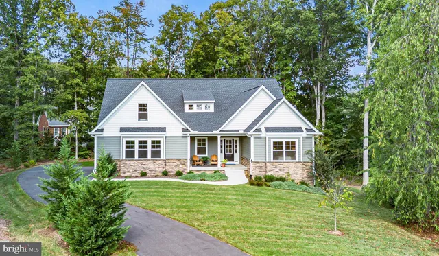a front view of a house with a yard table and chairs