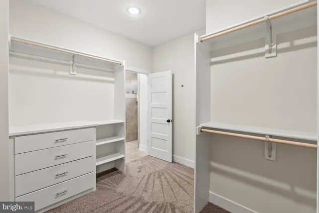 a view of a room with wooden floor and white walls