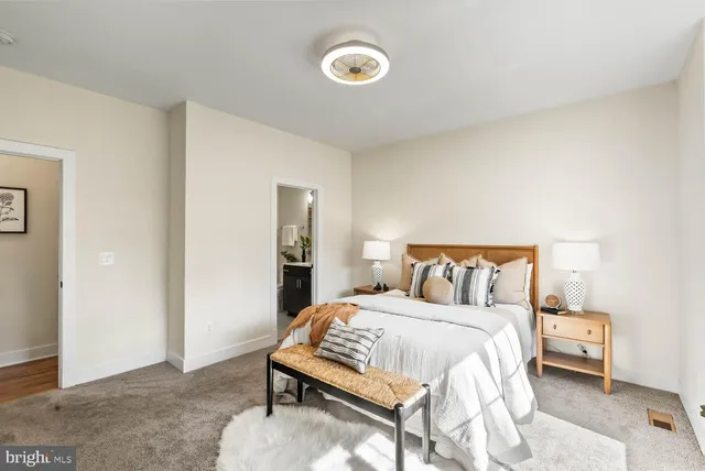 a bed room with two beds and painted walls