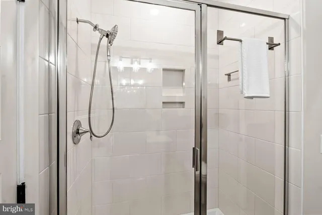 a bathroom with a sink a toilet a mirror a vanity and shower