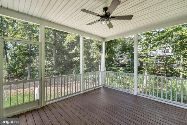 an empty room with wooden floor and entrance