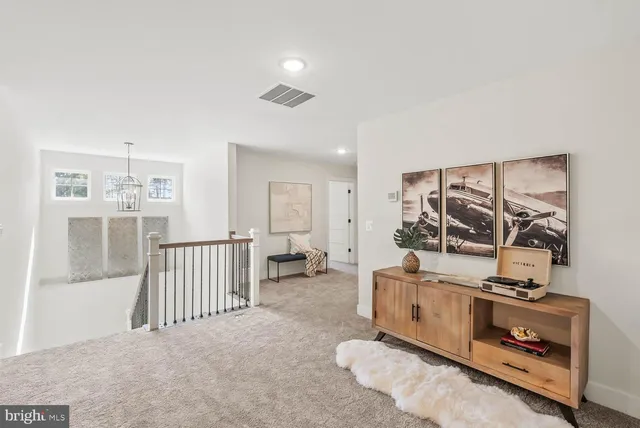 a view of a house with a yard and large trees