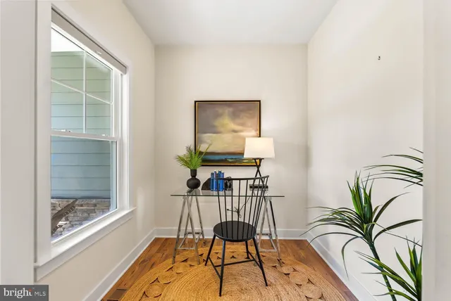 a living room with furniture kitchen view and a window