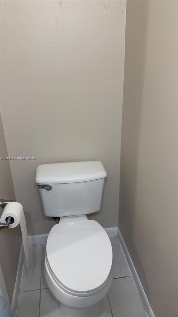 3908 Southwest 67th Terrace, Unit 112 Davie, FL 33314 - Photo 15 of 17 a white toilet sitting next to a white wall