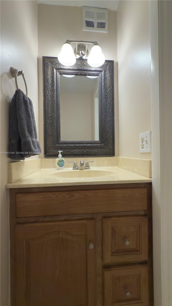 3908 Southwest 67th Terrace, Unit 112 Davie, FL 33314 - Photo 16 of 17 a bathroom with a sink and a mirror