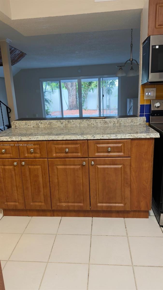 3908 Southwest 67th Terrace, Unit 112 Davie, FL 33314 - Photo 5 of 17 a stove top oven sitting inside of a kitchen