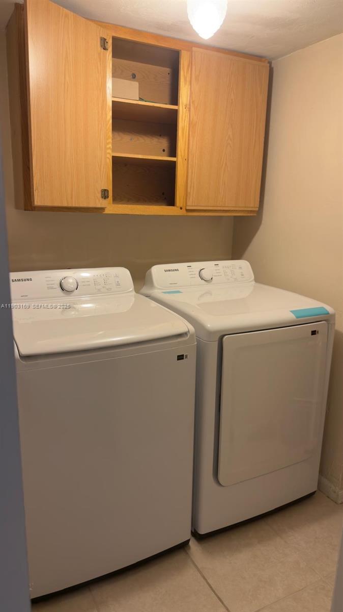 3908 Southwest 67th Terrace, Unit 112 Davie, FL 33314 - Photo 7 of 17 a utility room with dryer and washer