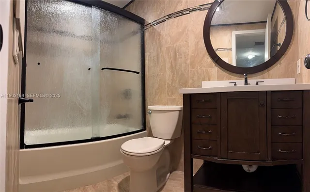 a bathroom with a toilet a sink and a mirror