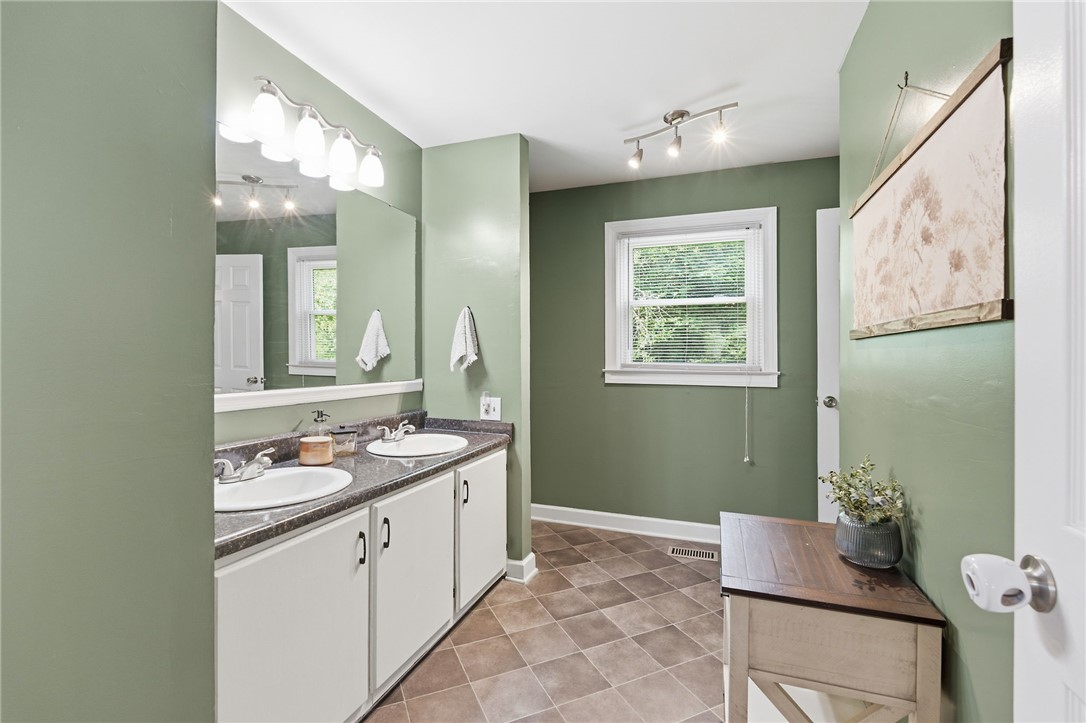 108 Tarrant Street Central, SC 29630 - Photo 22 of 42 Double vanity sinks and a bright window elevate daily routines in this well-appointed bathroom.