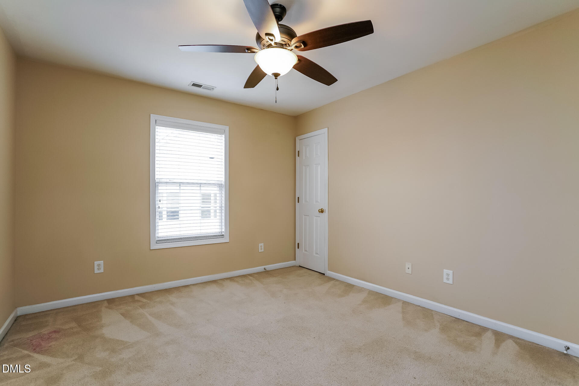 2279 Lazy River Drive Raleigh, NC 27610 - Photo 15 of 24 an empty room with windows and fan
