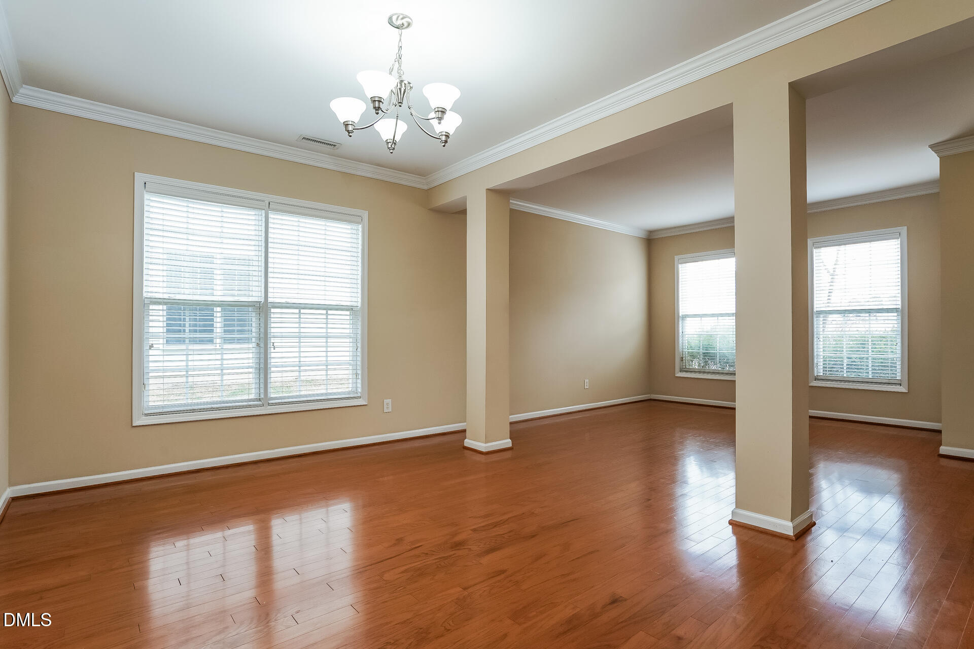 2279 Lazy River Drive Raleigh, NC 27610 - Photo 4 of 24 a view of an empty room with wooden floor and a window