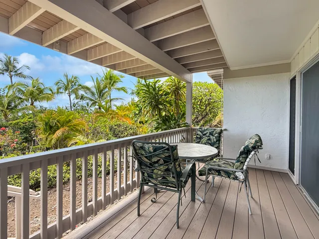 a view of a chairs and table in the balcony