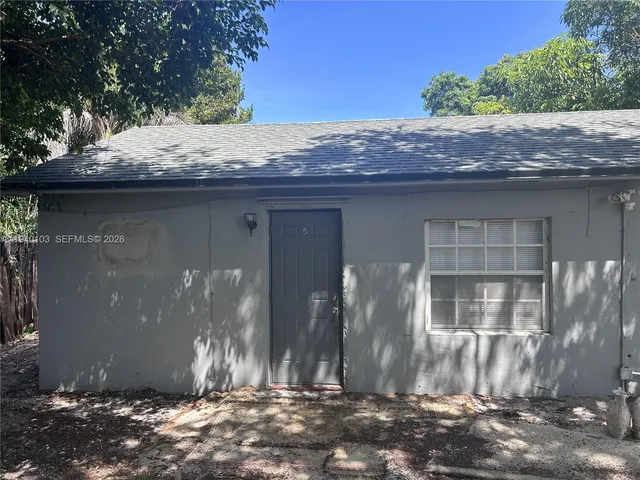 a kitchen with granite countertop a refrigerator and a stove top oven