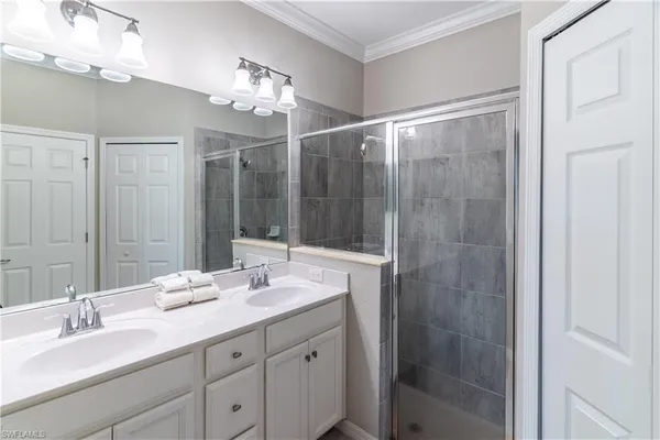 a bathroom with a double vanity sink and a mirror