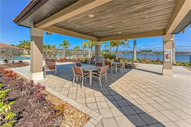 a view of a patio with a dining table chairs and iron floor